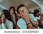 A diverse group of friends with terrified expressions together in a cinema to watch a horror film, experiencing a mix of fear, excitement, and laughter, as they collectively navigate through