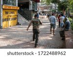 Small photo of New Delhi, India - 05-05-2020: People seen waiting outside a government liquor shop in Malviya Nagar after relaxations allowing their opening on May 5, 2020 in New Delhi, India.