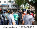 Small photo of New Delhi, India - 05-05-2020: People seen waiting outside a government liquor shop in Malviya Nagar after relaxations allowing their opening on May 5, 2020 in New Delhi, India.