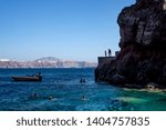 Cliff diving and swimming in Santorini Oia Amoudi / Ammoudi bay