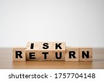 Flipping of wooden cubes block which print screen risk and return wording. Investment concept about balance between risk and return.