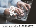 Businessman using laptop computer with quality assurance and document icon for ISO or International Standard Organisation which related quality control and continuous improvement concept.