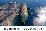 Small photo of Aerial drone photo of LNG (Liquified Natural Gas) tanker anchored in small LNG industrial islet of Revithoussa equipped with tanks for storage, Salamina, Greece