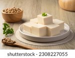 Small photo of Fresh Sliced Soft Tofu soy bean curd on white plate