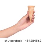 hand holding blank crispy ice cream cone isolated on white background.