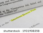 Closeup of the documents of both the Cares Act (Coronavirus Aid, Relief, and Economic Security Act) and the American Rescue Plan Act (ARPA) of 2021.