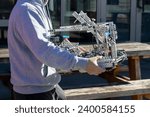 Small photo of Berkeley, CA, USA - Nov 19, 2023: A student carries a robot at the VEX Worlds Championship qualifying One World Showcase Event at UC Berkeley. VEX Robotics is an educational robotics program.