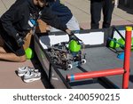 Small photo of Berkeley, CA, USA - Nov 19, 2023: A student is seen launching a triball with his robot during a practice at the VEX Robotics Worlds Championship qualifying One World Showcase Event at UC Berkeley.