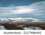 Street Highway Ring road No.1 in Iceland, with view towards massive glacier with beautiful lenticular clouds. Southern side if the country. Road trip travel concept.