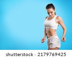 Small photo of Slim woman with measuring tape around the waist line. Fit girl measuring waistline with measure tape after diet.