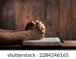 Man hands praying on the bible. Concept religion