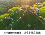 Rural mountain landscape with remote Romanian village uphill in the valleys of Carpathian mountains, in springtime