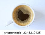 Cup of black coffee with lovely heart shaped froth  isolated on white background