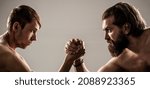 Small photo of Two man's hands clasped arm wrestling, strong and weak, unequal match. Heavily muscled bearded man arm wrestling a puny weak man.