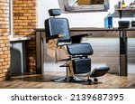 Small photo of Professional hairstylist in barbershop interior. Barber shop chair. Barbershop armchair, modern hairdresser and hair salon, barber shop for men. Stylish vintage barber chair.