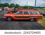 Small photo of Iola, WI - July 07, 2022: High perspective side view of a 1963 Ford Country Squire Station Wagon at a local car show.