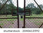 Small photo of A locked metal gate with padlock and chain, near Wiggington, in Hertfordshire, England.