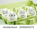 Small photo of Four eggs in eggbox. Types of temperaments. Sanguine, choleric, phlegmatic and melancholic.