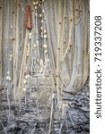 Small photo of Old fishing net, hangup for drying, along the shores of the Ligurian Sea (Mediterranean sea, Northern Italy). Color image.