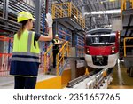 Young caucasian engineer woman or worker signal while engineer man checking electric train for planning maintenance in station, transport and infrastructure, inspector check service transport.
