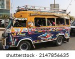 Small photo of DAKAR, SENEGAL – MARCH 15, 2022: Car rapide in Dakar city, Senegal, Africa. Senegalese traditional national transport, bus, taxi, transportation. Colorful car rapide. Custom autumobile, car. Traffic