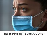 Small photo of Upset depressed melancholy sad crying woman in protective face mask with tears eyes during serious illness, coronavirus outbreak and flu covid-19 epidemic. Health problems difficulties