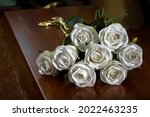 Small photo of Closed coffin with white roses on the coffin lid, death of a person, burial, mortality of the population.