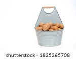 Walnuts In A Bucket On A White...