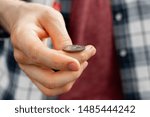 Small photo of close up shot of hand toss a coin, probable and winning chances concept, fifty-fifty