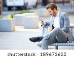Businessman on park bench with...