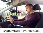 Male Driver Being Stopped By Female Traffic Police Officer With Digital Tablet For Driving Offence