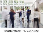 Staff In Busy Lobby Area Of Modern Hospital