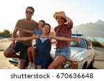 Portrait Of Family Standing Next To Classic Car