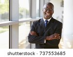 Portrait of a smiling businessman with arms crossed