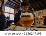 Small photo of Bruges, flanders, Belgium. August 2019. Interior of the historic de garre brewery. A mug of fine craft beer was served with a few pieces of cheese, the tasting takes place in this old-fashioned habit