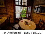 Small photo of Bruges, flanders, Belgium. August 2019. Interior of the historic de garre brewery. The wooden beams, the furniture, the brick walls announce a jump into the past.