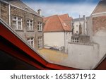 Small photo of Bruges, Flanders, Belgium. August 2019. View from a window of the historic de garre brewery: a skimpy alley, closed between houses in the historic center, leads to this hidden place.