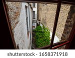 Small photo of Bruges, Flanders, Belgium. August 2019. View from a window of the historic de garre brewery: a skimpy alley, closed between houses in the historic center, leads to this hidden place.