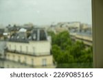 Paris, France, June 2022. View from above through a stained glass window of the old town during a rainy day. Conceptual image.