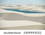 Small photo of Lencois Maranhenses National Park in Brazil, low, flat, flooded land, overlaid with large, discrete sand dunes with blue and green lagoons