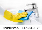 Small photo of Woman maid or charwoman cleaning modern new basin in bathroom banner. Water tap clean using yellow gloves and blue cloth.