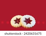 Linzer cookies on red background, isolated, copy space for text. Christmas time