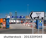 Small photo of Wirral, UK - Jul 17 2021: With foreground focus set on the Belfast Ferry sign, lorries queue the Stena Line roll on - roll off Liverpool to Belfast ferry Terminal in Birkenhead on the River Mersey.