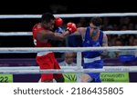Small photo of BIRMINGHAM, ENGLAND - AUGUST 4: Tyler Jolly of Scotland punches Neville Warupu of Papua New Guinea during the Men’s Over 63.5kg-67kg (Welterweight) - Quarter-Final fight on of the Commonwealth Games.