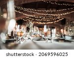 Beautiful wedding room with wedding table with food, flowers anddrinks, decorations,lights 