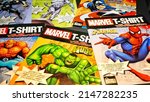 Small photo of Rome, Italy - April 12, 2022, detail of Marvel comic book covers with datasheets inside, sold together with the t-shirts.