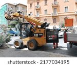 Small photo of Rome, Italy - July 08, 2022, detail of a Bobcat excavator for the remaking of the sutterranean pipes and the road surface for the viability.