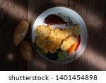 Small photo of Crispy slice potato chips and potato heads Placed on a snack plate Ready to serve With a little sun shining