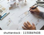 architect design working drawing sketch plans blueprints and making architectural construction model in architect studio