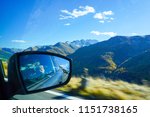 Grossglockner, Austria : Tourist holding camera in hand and taking a picture inside the car during on Grossglockner High Alpine Road in Austria.